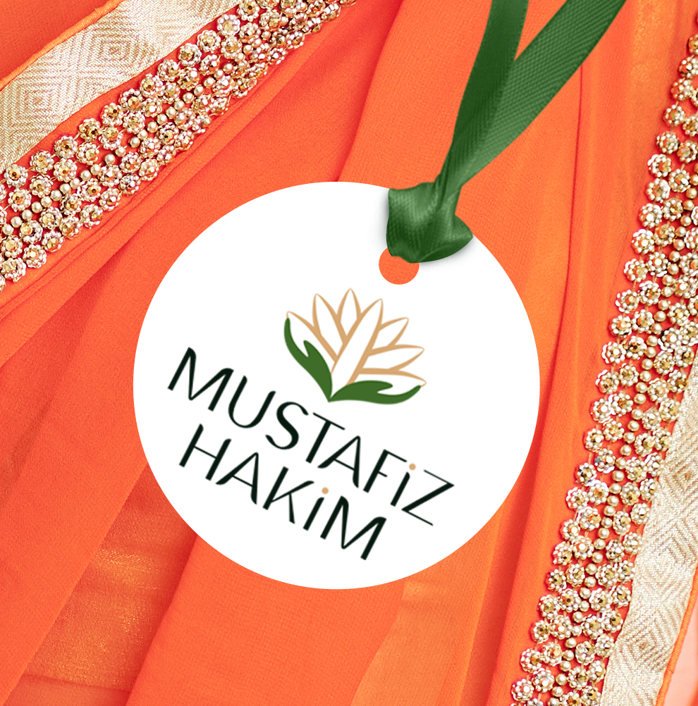 Mustafiz Hakim logo designed by Sojo Creative, featuring a modern leaf motif in gold and green. Displayed on a swing tag with green ribbon tied to it on an orange and gold sari fabric background.